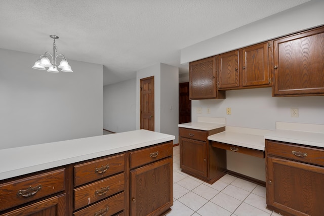 2321 Worthingwoods Blvd, Powell, OH 43065 - kitchen with light countertops, light tile patterned floors, a chandelier, decorative light fixtures, and a textured ceiling