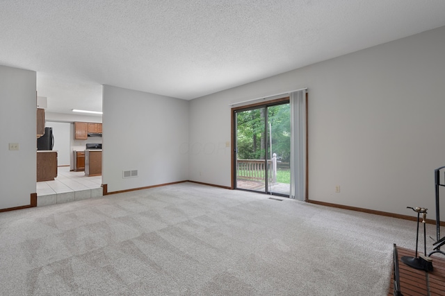 2321 Worthingwoods Blvd, Powell, OH 43065 - unfurnished living room featuring light colored carpet, a textured ceiling, and baseboards