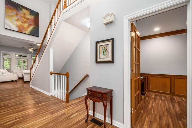 5552 Quail Hollow Way, Westerville, OH 43082 - hallway with wood finished floors, a wainscoted wall, and an upstairs landing
