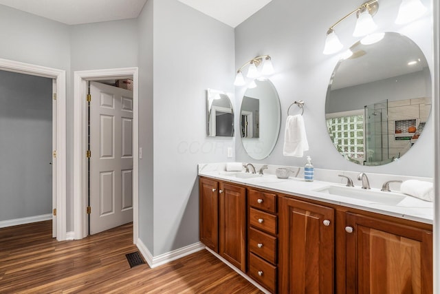 5552 Quail Hollow Way, Westerville, OH 43082 - full bath featuring double vanity, wood finished floors, a tile shower, and baseboards