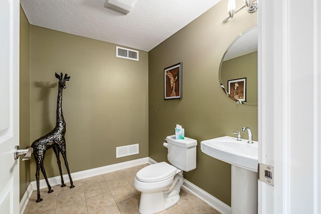 5552 Quail Hollow Way, Westerville, OH 43082 - bathroom with toilet, a textured ceiling, tile patterned floors, and baseboards