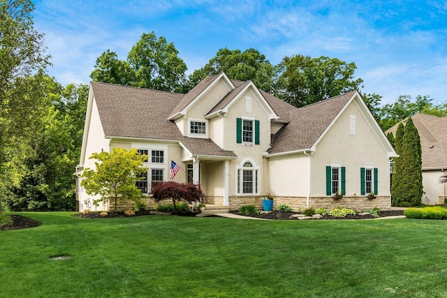 5552 Quail Hollow Way, Westerville, OH 43082 - traditional-style home with stucco siding, stone siding, a front yard, and roof with shingles