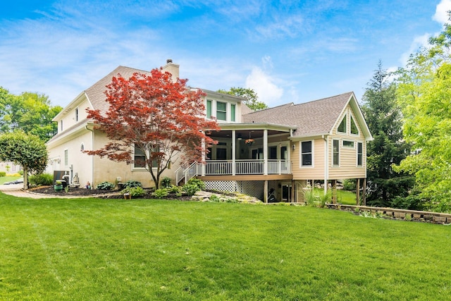 5552 Quail Hollow Way, Westerville, OH 43082 - back of property with a sunroom, a chimney, a lawn, and a shingled roof