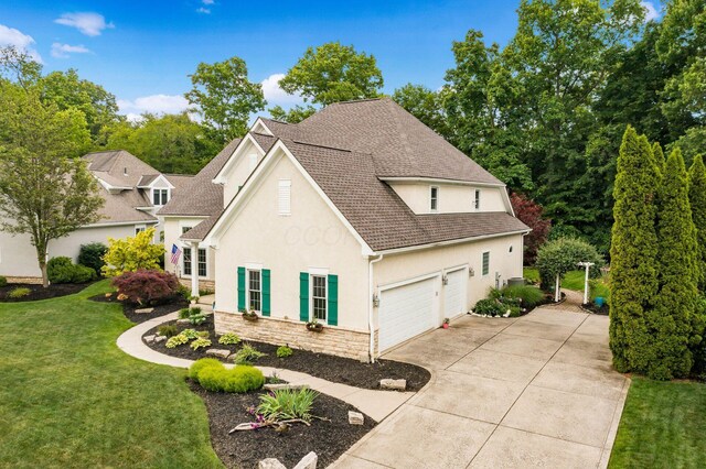 5552 Quail Hollow Way, Westerville, OH 43082 - view of front facade featuring stucco siding, driveway, a front lawn, and a shingled roof