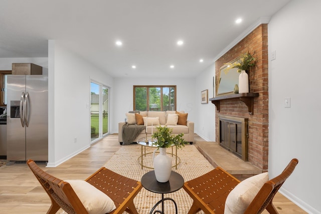 5148 Riverbirch Dr N, Columbus, OH 43229 - living area featuring a brick fireplace, light wood-style flooring, recessed lighting, and baseboards