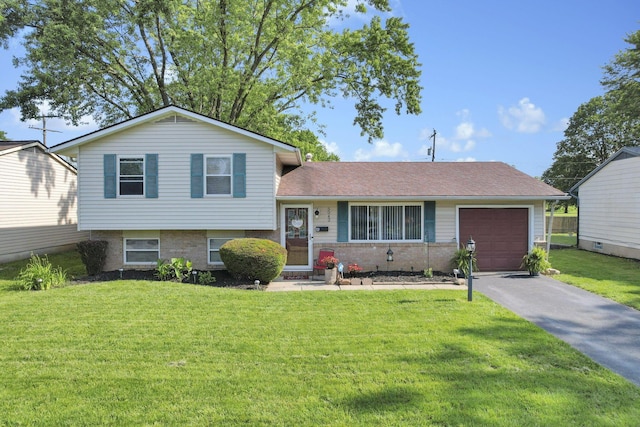 5042 Lindora Dr, Columbus, OH 43232 - tri-level home featuring an attached garage, concrete driveway, a front lawn, and brick siding