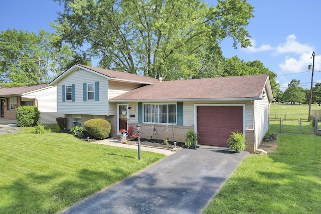 5042 Lindora Dr, Columbus, OH 43232 - tri-level home featuring an attached garage, driveway, brick siding, and a shingled roof