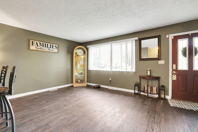 5042 Lindora Dr, Columbus, OH 43232 - entryway with dark wood-style floors, a textured ceiling, and baseboards