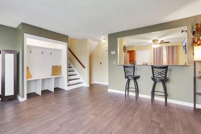 5042 Lindora Dr, Columbus, OH 43232 - unfurnished living room featuring wood finished floors, stairs, a ceiling fan, and baseboards