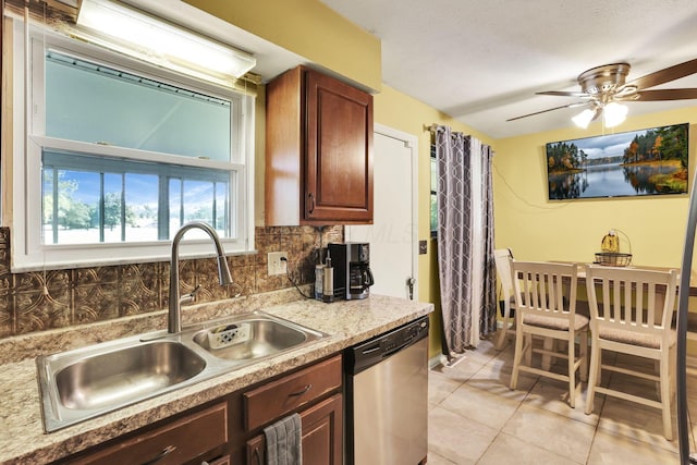 5042 Lindora Dr, Columbus, OH 43232 - kitchen with dishwasher, a sink, light countertops, backsplash, and light tile patterned floors