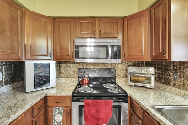 5042 Lindora Dr, Columbus, OH 43232 - kitchen featuring appliances with stainless steel finishes, brown cabinets, and backsplash