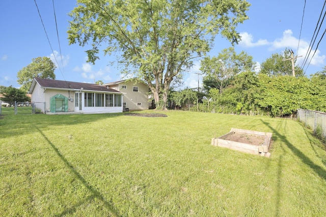 5042 Lindora Dr, Columbus, OH 43232 - view of yard featuring a vegetable garden and a sunroom