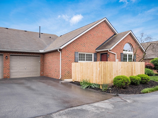 2594 Roberts Ct, Hilliard, OH 43026 - view of front facade featuring brick siding, an attached garage, asphalt driveway, and roof with shingles