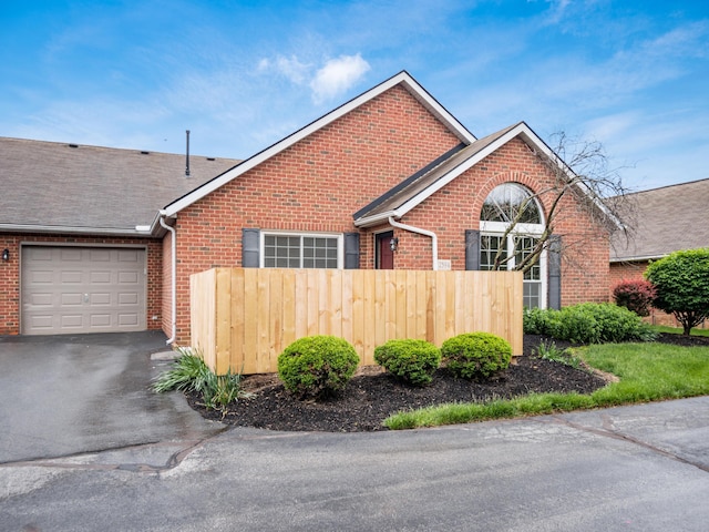 2594 Roberts Ct, Hilliard, OH 43026 - view of front of house featuring brick siding, an attached garage, driveway, and a shingled roof
