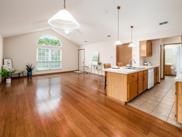 2594 Roberts Ct, Hilliard, OH 43026 - kitchen with white appliances, light countertops, a sink, lofted ceiling, and pendant lighting