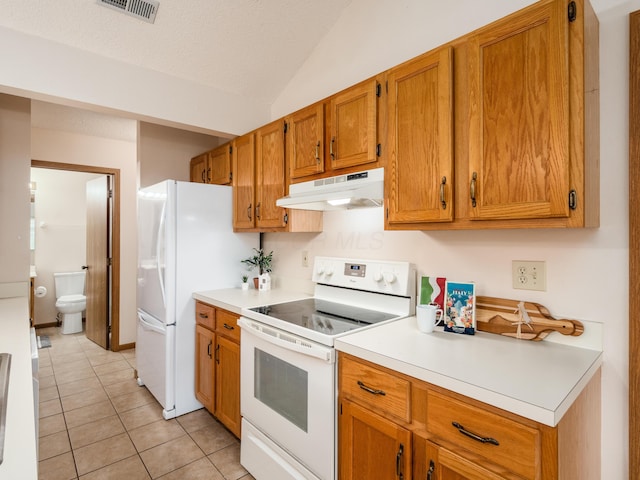 2594 Roberts Ct, Hilliard, OH 43026 - kitchen featuring white appliances, under cabinet range hood, light countertops, brown cabinetry, and vaulted ceiling