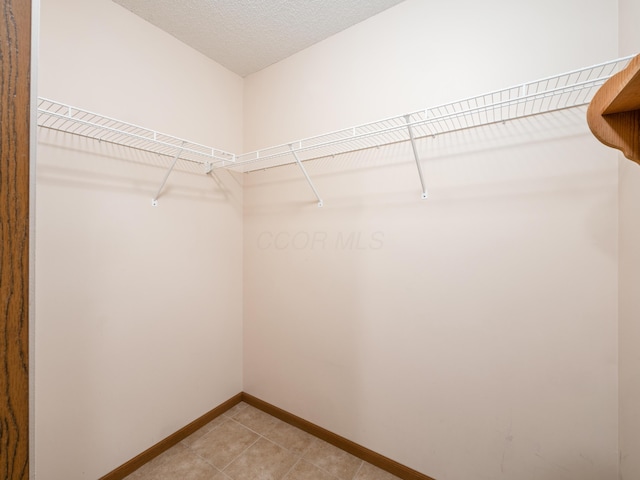 2594 Roberts Ct, Hilliard, OH 43026 - spacious closet featuring light tile patterned flooring