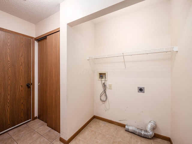2594 Roberts Ct, Hilliard, OH 43026 - laundry room featuring hookup for an electric dryer, hookup for a washing machine, light tile patterned floors, baseboards, and a textured ceiling