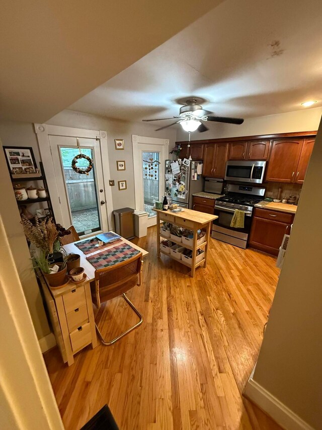 688 S 5th St, Columbus, OH 43206 - kitchen with stainless steel appliances, light wood-style flooring, ceiling fan, and light countertops