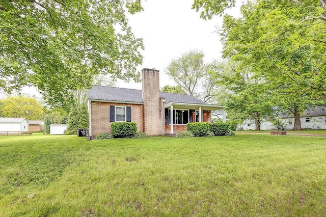 11 Mermary Dr, Fredericktown, OH 43019 - view of front facade featuring a chimney, brick siding, and a front yard