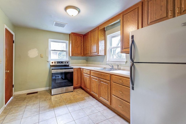 11 Mermary Dr, Fredericktown, OH 43019 - kitchen featuring freestanding refrigerator, electric stove, a sink, and plenty of natural light