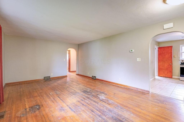 11 Mermary Dr, Fredericktown, OH 43019 - unfurnished room featuring arched walkways, light wood finished floors, and baseboards