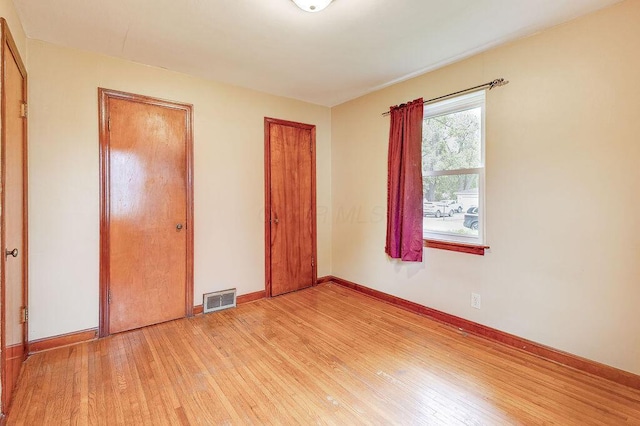 11 Mermary Dr, Fredericktown, OH 43019 - unfurnished bedroom with light wood-style floors, baseboards, and two closets