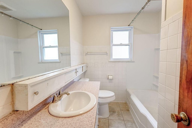 11 Mermary Dr, Fredericktown, OH 43019 - bathroom featuring tile walls, plenty of natural light, toilet, tile patterned floors, and wainscoting