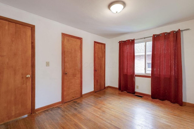 11 Mermary Dr, Fredericktown, OH 43019 - unfurnished bedroom featuring light wood finished floors, baseboards, and two closets