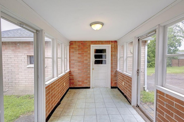 11 Mermary Dr, Fredericktown, OH 43019 - unfurnished sunroom featuring brick wall and tile patterned floors