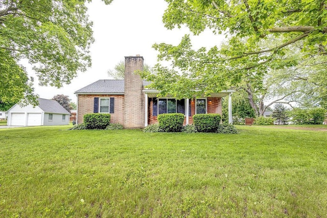 11 Mermary Dr, Fredericktown, OH 43019 - view of front of home with a detached garage, a front yard, a chimney, and brick siding