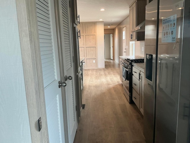 8565 Smith Calhoun Rd Unit 48, Plain City, OH 43064 - kitchen featuring appliances with stainless steel finishes, range hood, wood finished floors, light countertops, and recessed lighting