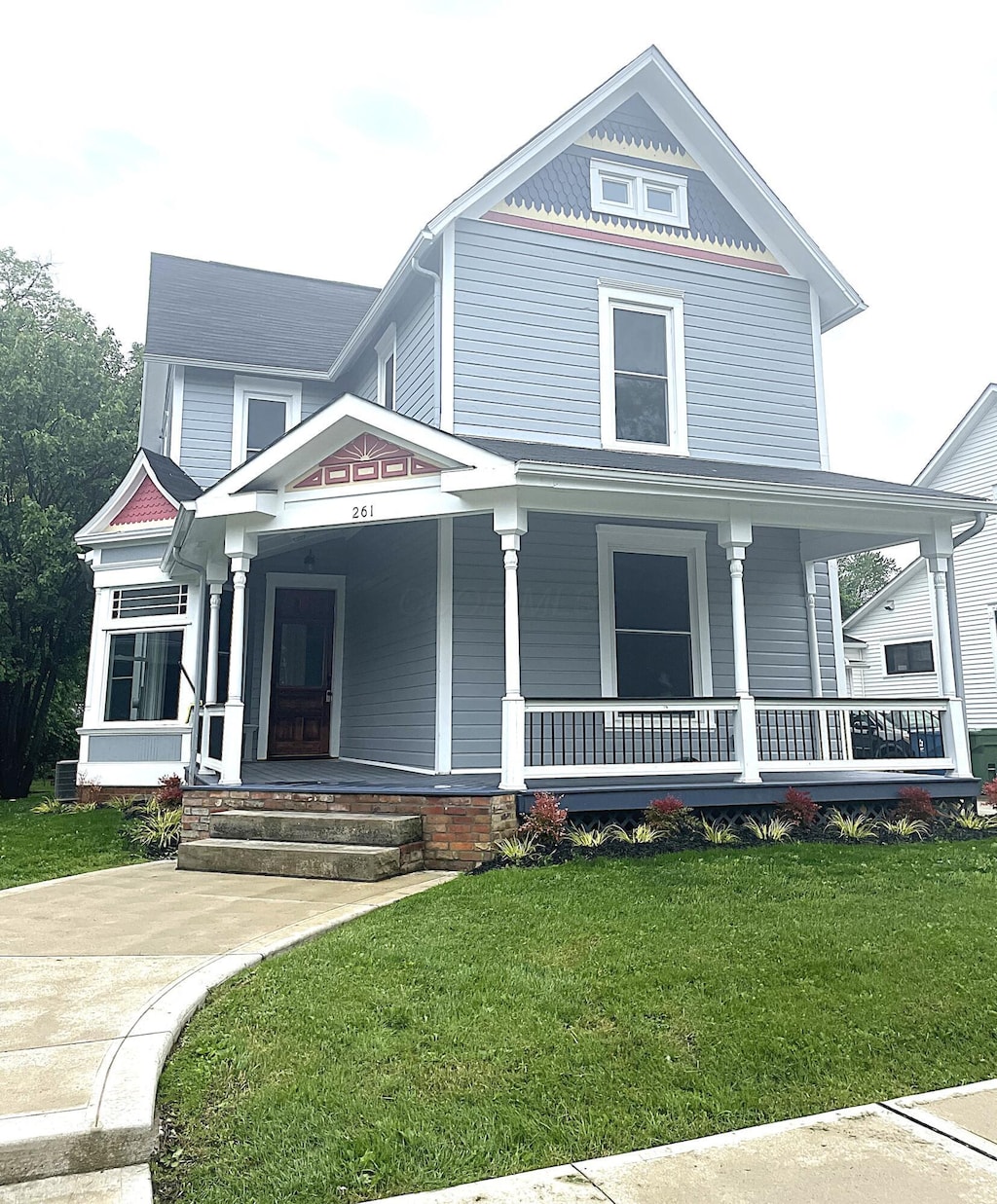 261 W 6th St, Marysville, OH 43040 - victorian home featuring covered porch and a front lawn