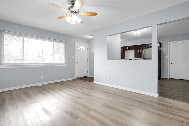 4980 Comstock Dr, Columbus, OH 43232 - foyer entrance with ceiling fan, light wood finished floors, and baseboards