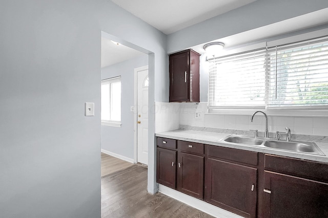 4980 Comstock Dr, Columbus, OH 43232 - kitchen with a sink, wood finished floors, light countertops, and dark brown cabinetry