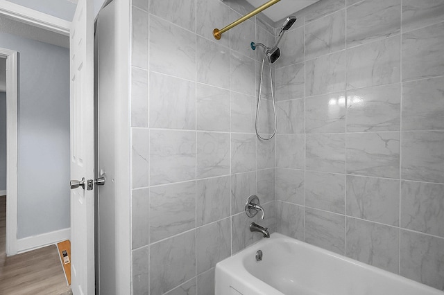 4980 Comstock Dr, Columbus, OH 43232 - bathroom featuring shower / bath combination, wood finished floors, and baseboards