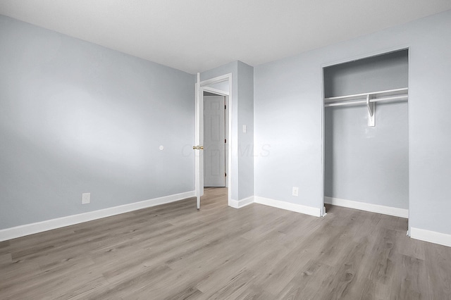 4980 Comstock Dr, Columbus, OH 43232 - unfurnished bedroom featuring wood finished floors, a closet, and baseboards