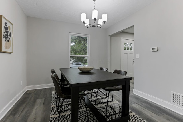 338 Gentlewind Dr, Westerville, OH 43081 - dining space featuring a chandelier, dark wood-style floors, healthy amount of natural light, and a textured ceiling