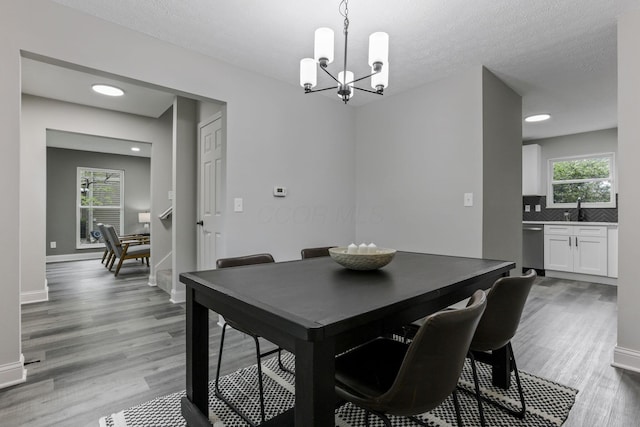 338 Gentlewind Dr, Westerville, OH 43081 - dining room featuring a chandelier, light wood finished floors, healthy amount of natural light, baseboards, and recessed lighting