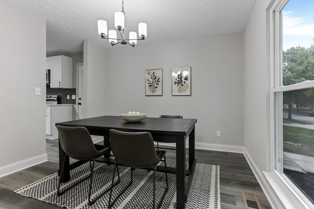 338 Gentlewind Dr, Westerville, OH 43081 - dining space with a chandelier, dark wood-style flooring, baseboards, and a textured ceiling