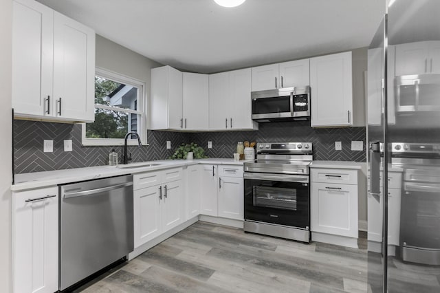 338 Gentlewind Dr, Westerville, OH 43081 - kitchen with appliances with stainless steel finishes, light countertops, a sink, and white cabinets