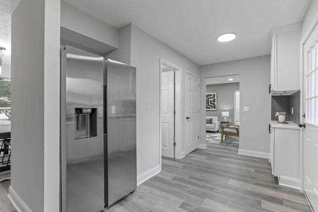 338 Gentlewind Dr, Westerville, OH 43081 - kitchen with stainless steel refrigerator with ice dispenser, white cabinets, light wood-type flooring, baseboards, and light countertops