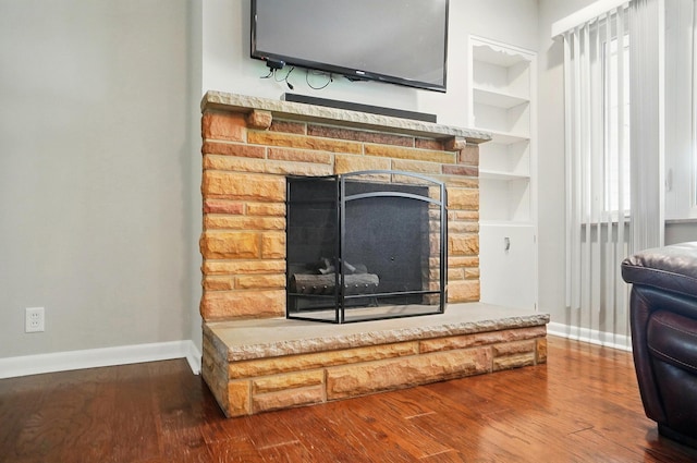 1096 Lancaster Ave, Reynoldsburg, OH 43068 - detailed view of baseboards, a fireplace, wood finished floors, and built in shelves