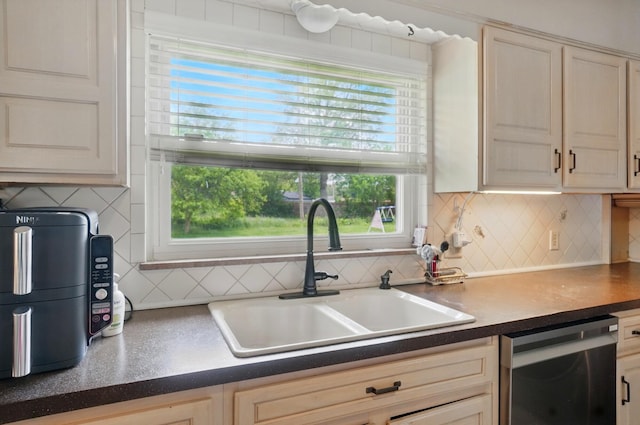 1096 Lancaster Ave, Reynoldsburg, OH 43068 - kitchen featuring stainless steel dishwasher, a sink, decorative backsplash, and plenty of natural light