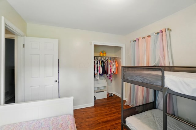 1096 Lancaster Ave, Reynoldsburg, OH 43068 - bedroom with wood finished floors, a walk in closet, a closet, and baseboards