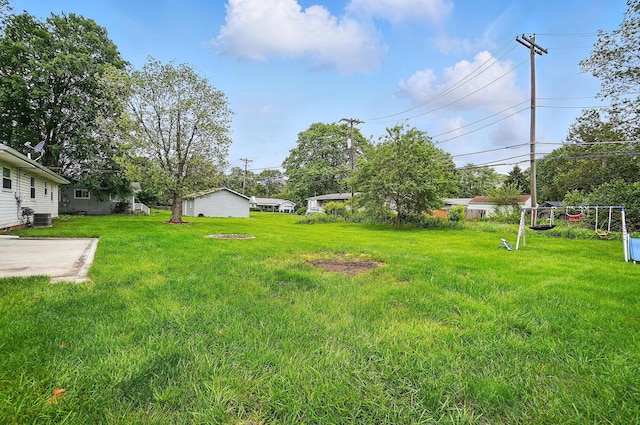 1096 Lancaster Ave, Reynoldsburg, OH 43068 - view of green lawn featuring central AC unit and a patio