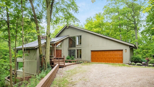 4171 Clotts Rd, Columbus, OH 43230 - mid-century inspired home featuring dirt driveway, a deck, and a garage