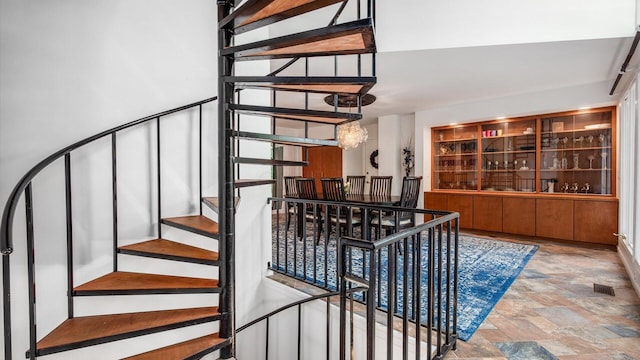 4171 Clotts Rd, Columbus, OH 43230 - stairway with stone finish floors and a chandelier