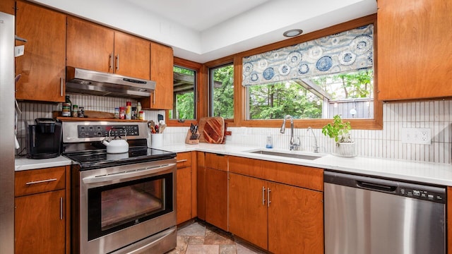 4171 Clotts Rd, Columbus, OH 43230 - kitchen with stainless steel appliances, under cabinet range hood, a sink, and plenty of natural light