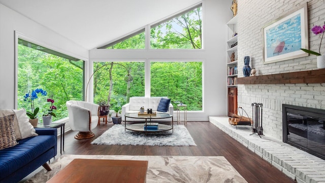 4171 Clotts Rd, Columbus, OH 43230 - living room featuring a brick fireplace, vaulted ceiling, wood finished floors, and built in features